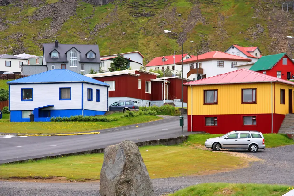 Färgglada hus i Ólafsvík med ett stenblock i förgrunden