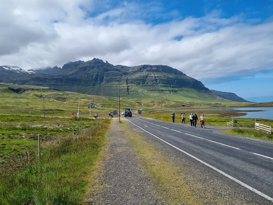 Straße 54 bei Grundarfjörður mit Grasstreifen und Bergen
